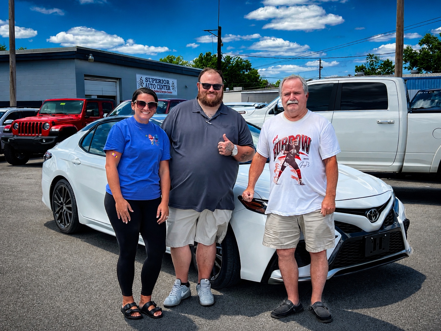 Darrell with customers and a white Toyota Camry