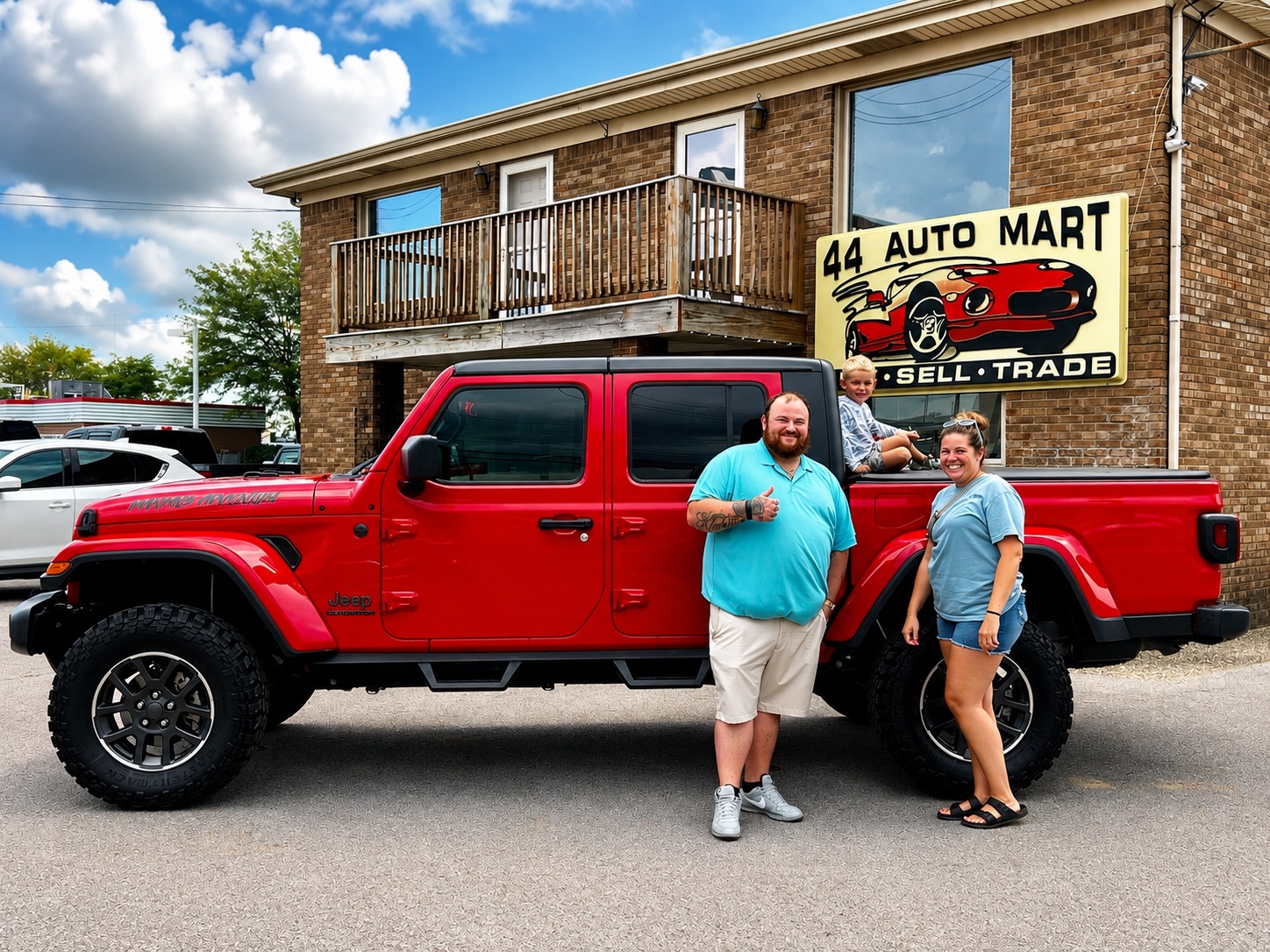 Darrell with a customer and a red Jeep Gladiator