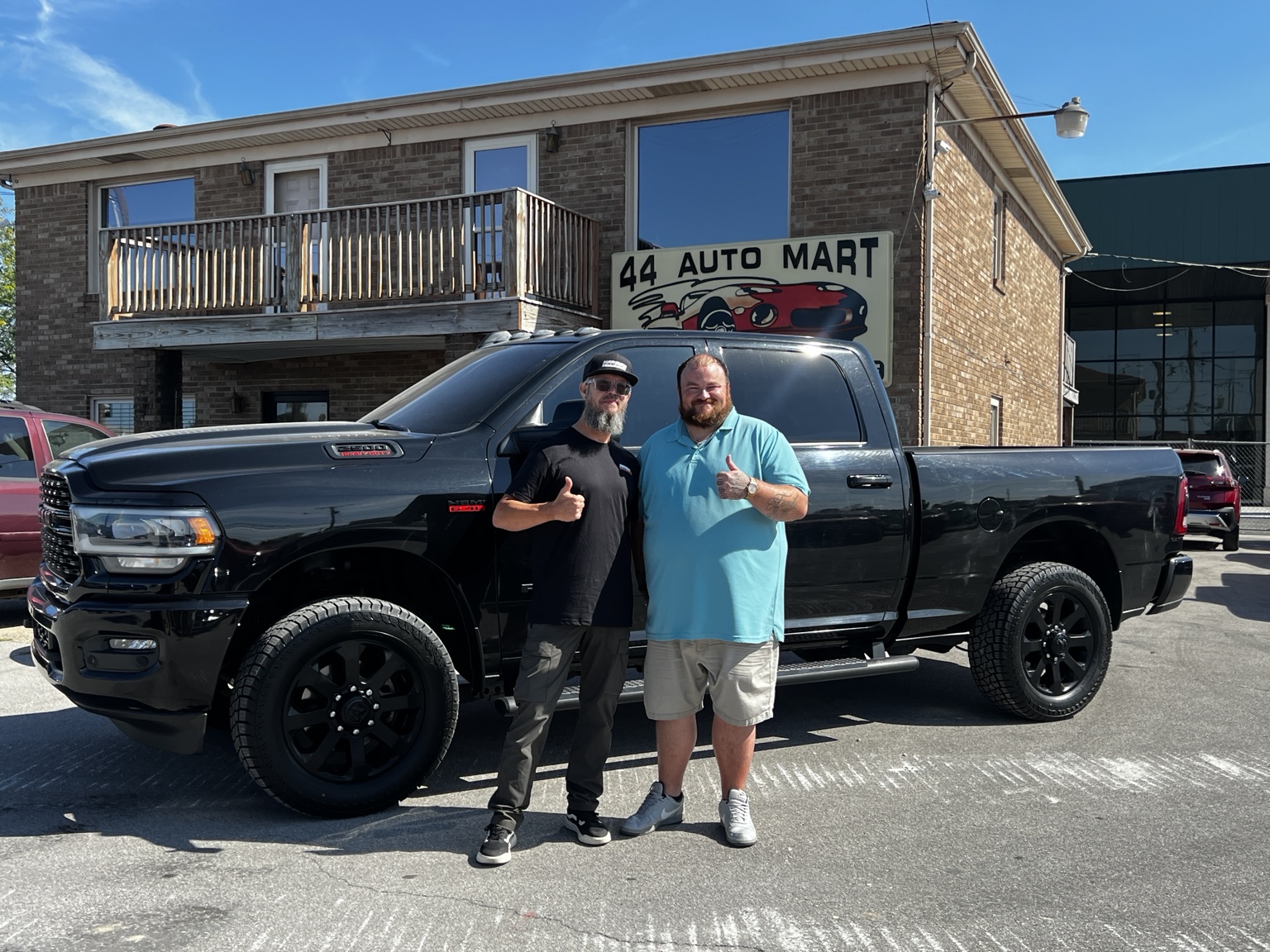 Darrell with a customer and a black Ram 2500