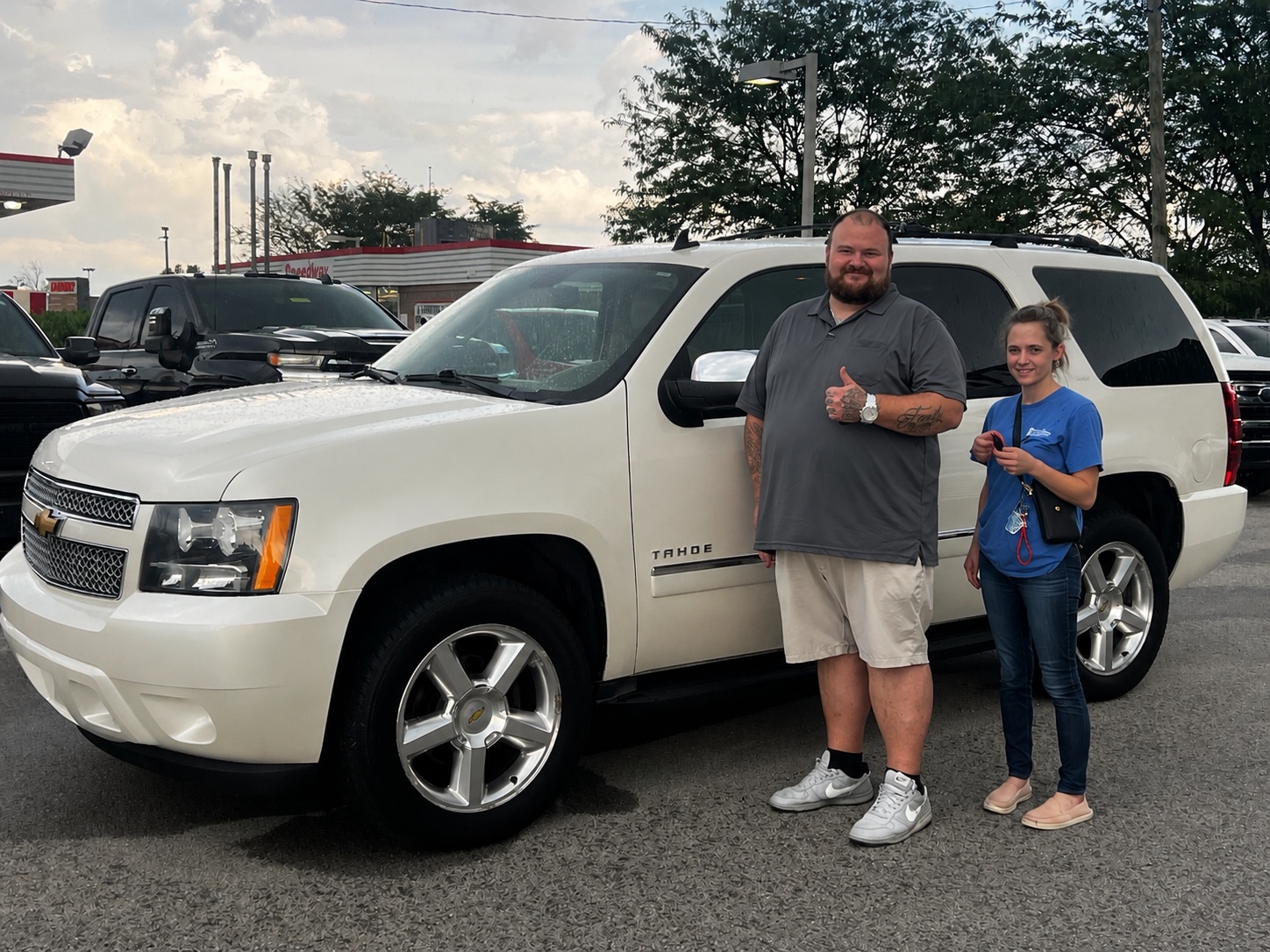 Darrell with a customer and a white Chevrolet Tahoe